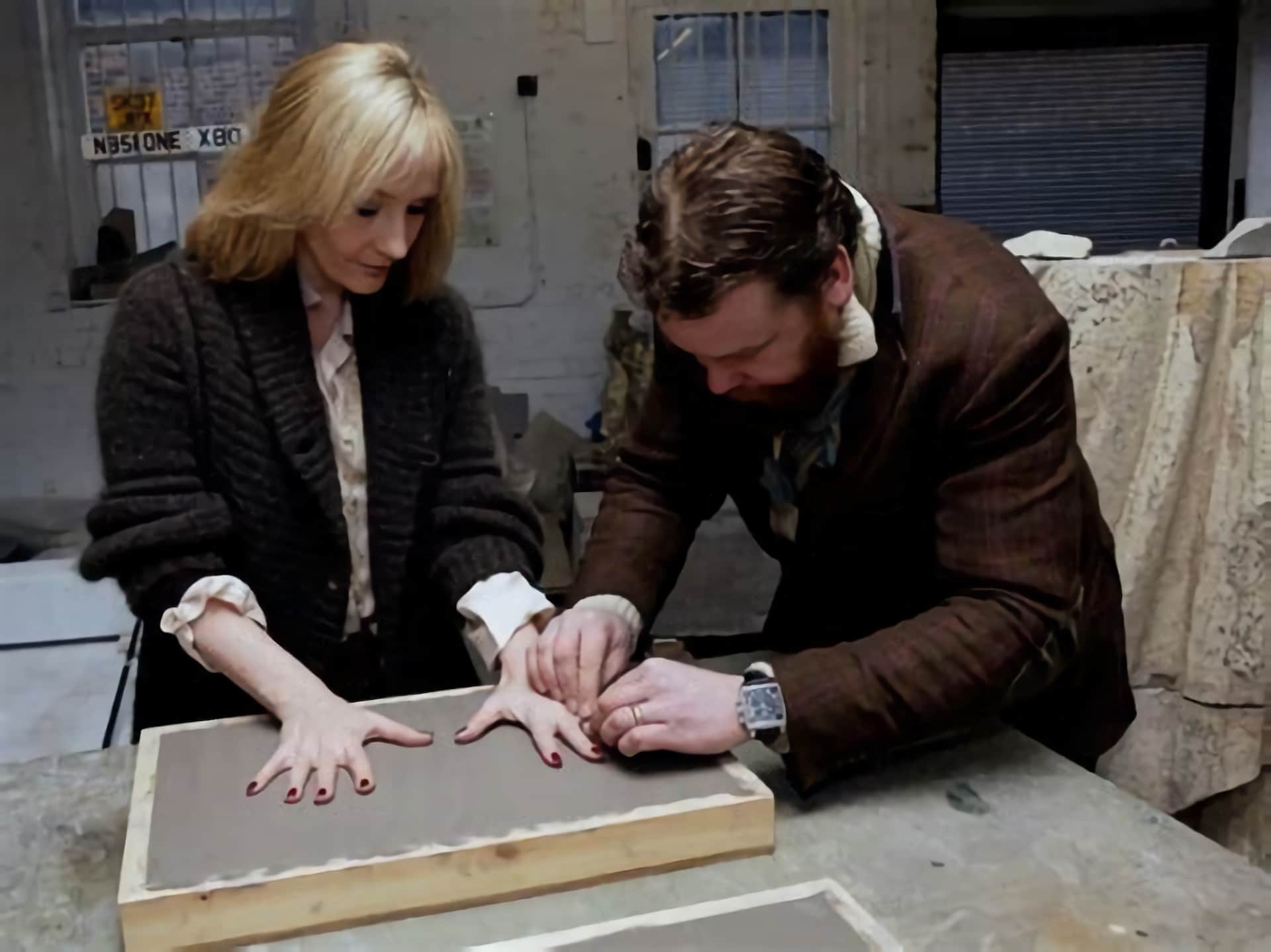 JK Rowling pressing her hands into clay for the sculptor of her Edinburgh Award