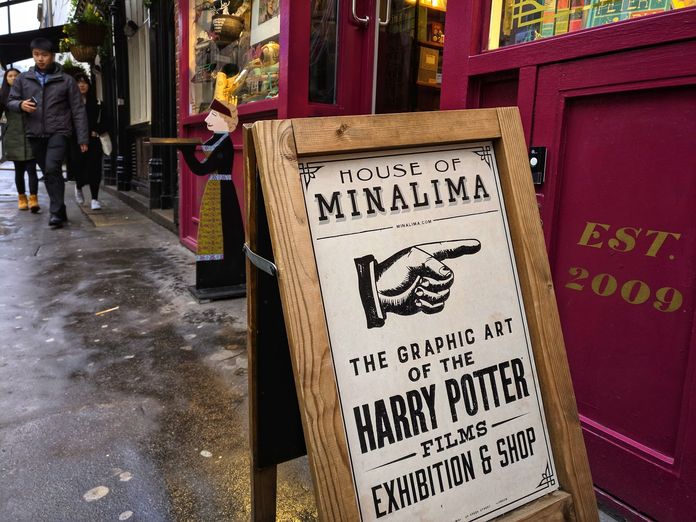 A finger points to Harry Potter Museum house of MinaLima